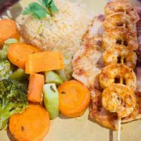 Pollo Arandas · Grilled chicken breast served with shrimp on top and rice with steamed veggies on the side.