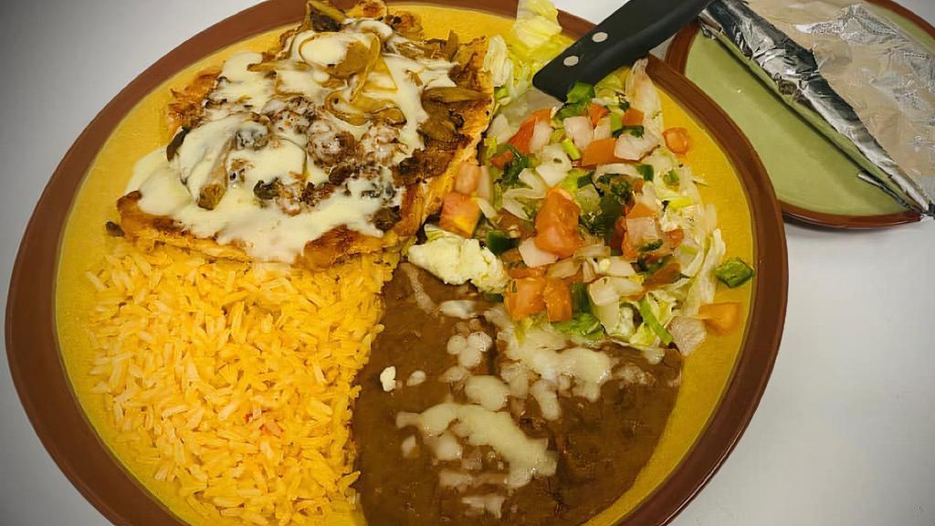 Pollo Rico · 8 oz grilled chicken breast cooked with chorizo, mushrooms, onions and cheese. Served with rice, beans, tortillas and a salad.