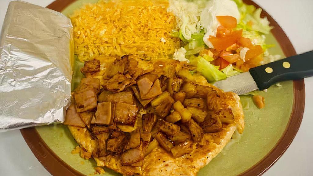 Pollo Hawaiano · Chicken breast topped with ham and pineapple, served with rice, lettuce, tomato, sour cream and tortillas.