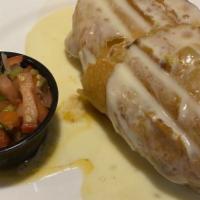 Chimichanga · One Chimichanga served with Pico De Gallo
and covered in Queso Sauce.
