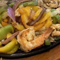 Fajitas · Your choice, sizzling with Onions & Bell Peppers with Lettuce, Tomato, Sour Cream, Guacamole...
