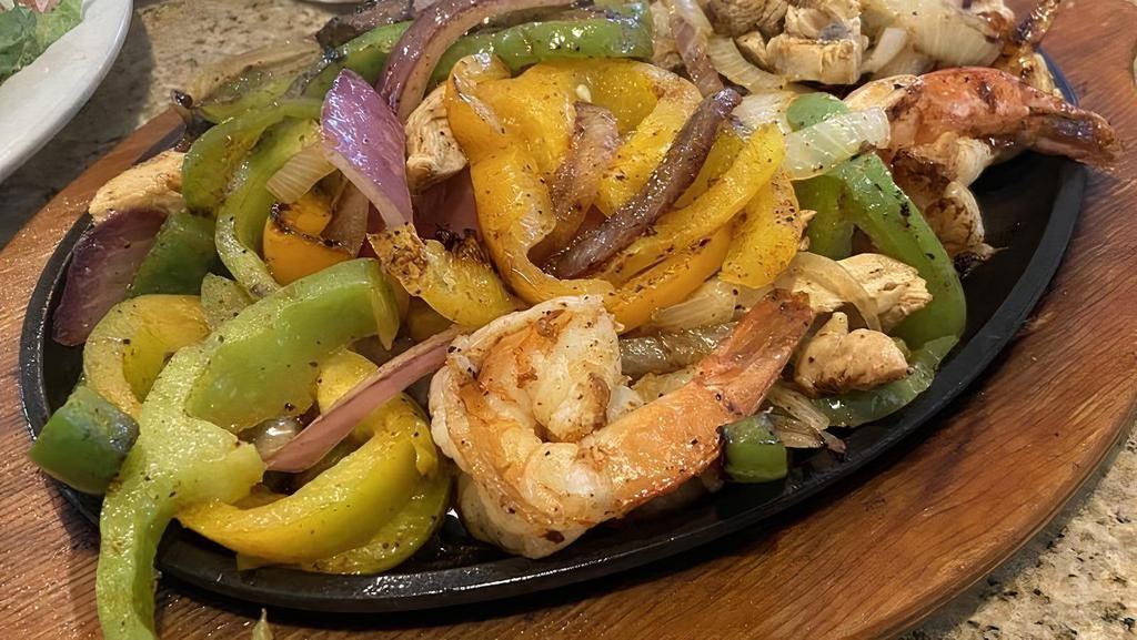 Fajitas · Your choice, sizzling with Onions & Bell Peppers with Lettuce, Tomato, Sour Cream, Guacamole & Corn, Flour or Wheat Tortillas; served with Rice & your choice of Charro or Refried Beans.