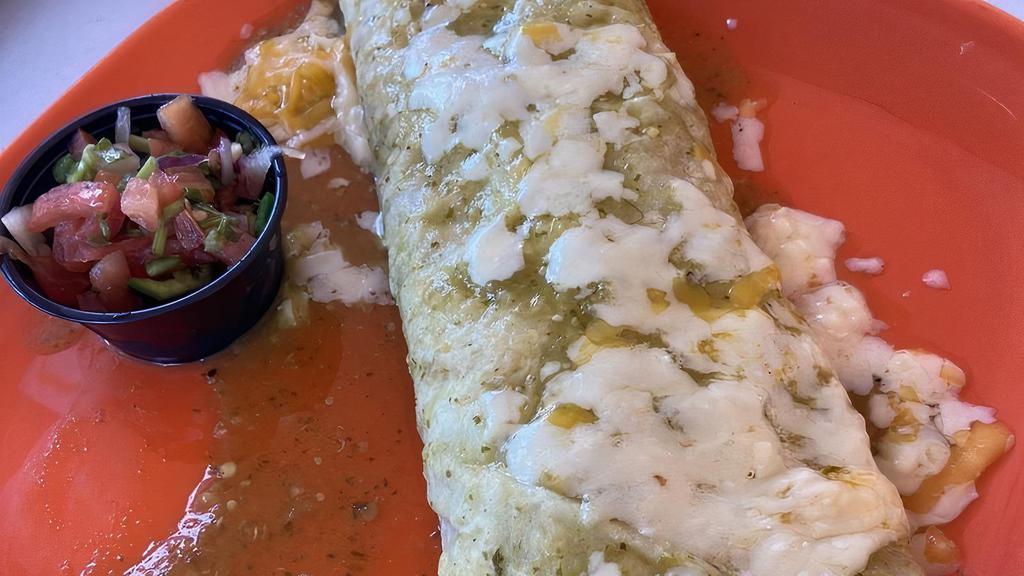 Burrito Asado · A favorite in Mexico. Stuffed with beans and your choice of grilled chicken, steak or shrimp, topped with salsa verde & cheese sauce. served with lettuce, guacamole, sour cream & pico de gallo.