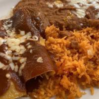 Enchiladas Dinner · Two Beef or Chicken Enchiladas; served with
Rice & Refried Beans, Topped with Red Sauce.