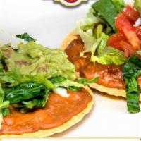 Chalupas · Two Corn Tortillas with Beans, Cheese, Lettuce, Tomatoes & Guacamole on top.