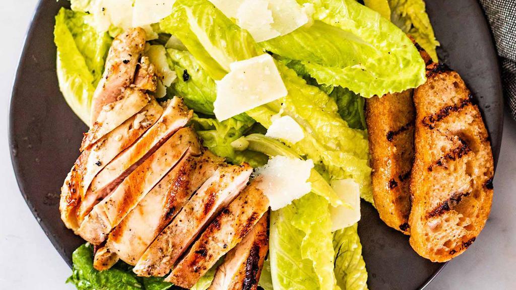 Grilled Chicken Avocado Salad · Sliced avocado with a variety of vegetables and grilled chicken.