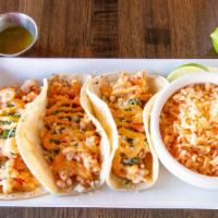 Shrimp Tacos  · Three corn tortillas stuffed with grilled shrimp, seared with tomatoes & onions. Topped with...