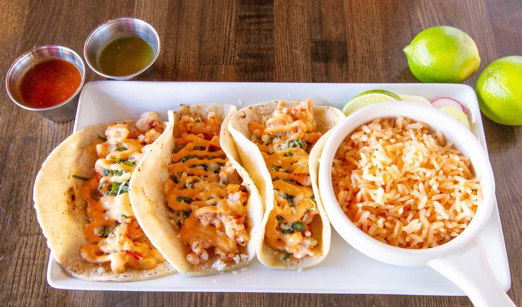 Shrimp Tacos  · Three corn tortillas stuffed with grilled shrimp, seared with tomatoes & onions. Topped with Chipotle Salsa