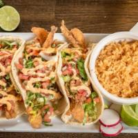 California Fish Tacos  · Three Delicious California Fish Tacos are loaded up with battered white fish. Topped with Pi...