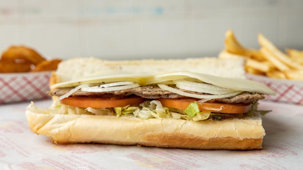 Grub Steak & Cheese Sub (Half) · Dressed with fresh provolone cheese, lettuce, tomato, onions, spices, oil, and vinegar.