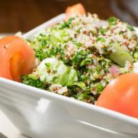Quinoa Tabbouleh · A mix of quinoa, chopped tomatoes, green onions, parsley and mint, on a bed of lettuce. Best...