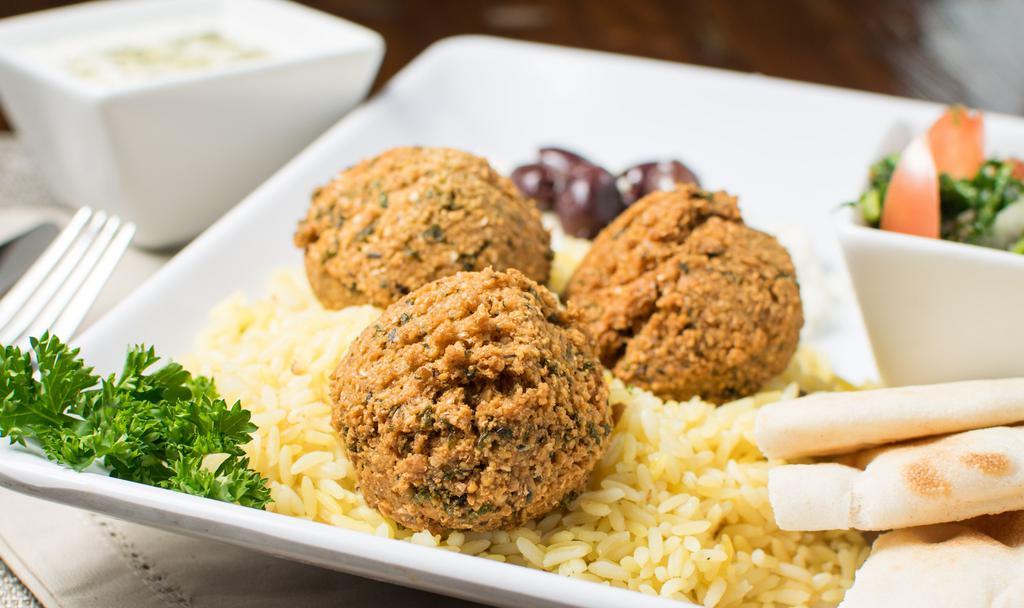 Falafel Platter · Falafel served atop rice pilaf, with your choice of house or tabbouleh salad and pita bread.