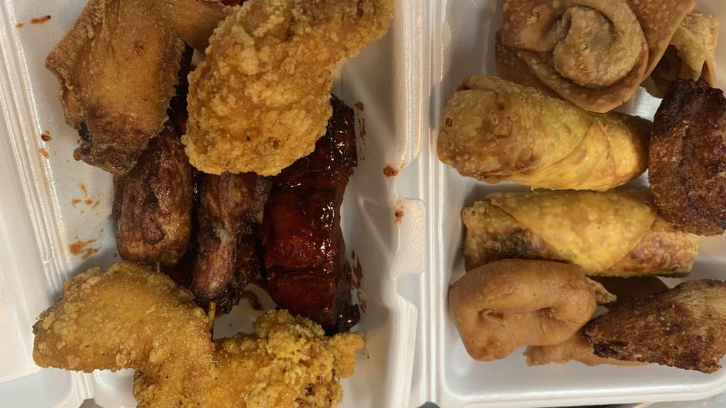 Pu Pu Platter (2) 宝宝盘 · 4 Chicken Wings, 2 Ribs, 2 Fried Woton, 2 Chicken Sticks,2 Egg Roll, 2  Fried Jumbo Shrimp and 2 Shrimp Toast with Sweet Sour Sauce