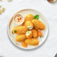 Jalapeno Poppers · Fried jalapeños filled with gooey melty cheese, served with ranch.