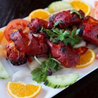 Tandoori Chicken · Chicken marinated in yogurt herb and spices.