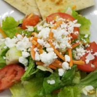 House Salad With House Vinaigrette · Romaine, shredded cabbages and carrots, cucumbers & tomatoes, feta cheese, and pita bread.