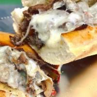Philly Cheesesteak Sub · Rib eye steak, grilled onions, sweet peppers & white American Cheese