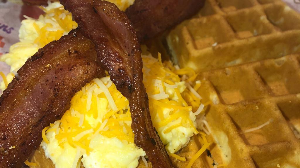 Breakfast Sandwich: Between The Waffle  · Freshly Baked Belgian Waffle, Hand Cracked Scrambled Eggs with your choice of Protein, Real butter & Momma's  house syrup