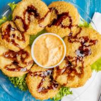 Fried Green Tomatoes · Lightly breaded tomatoes drizzled with a balsamic glaze and served with a remoulade sauce.