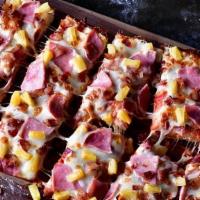 Hawaiian · Pizza sauce, premium mozzarella, ham, bacon & pineapple.  *Shown with deep dish crust*