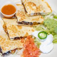 Coyote Fajita Quesadilla · Flour tortilla filled with cheese, grilled steak, chicken, or shrimp. Served with lettuce, t...