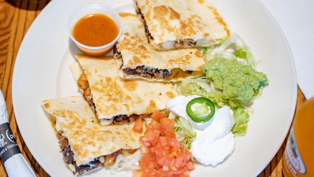 Coyote Fajita Quesadilla · Flour tortilla filled with cheese, grilled steak, chicken, or shrimp. Served with lettuce, tomato, sour cream and guacamole.