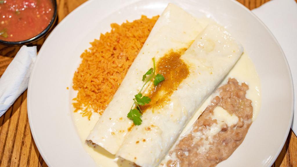 Dos Amigos Burrito · Two ground beef burritos topped with salsa ranchera and queso blanco. Served with Mexican rice and beans.
