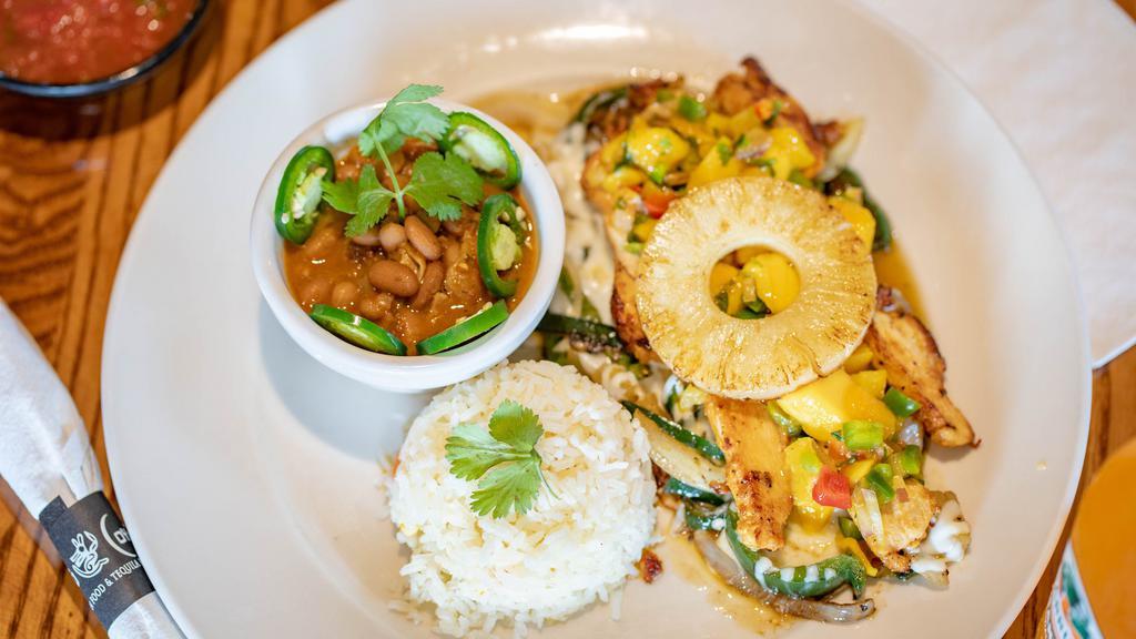 Pollo Tropical · Flame-grilled lemon and pepper chicken breast, sautéed poblano peppers, mushrooms, onions, pineapple and Mexican cheese, topped in a mango and roasted chile de arbol tomatillo salsa.
