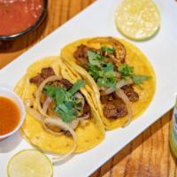 3 Al Carbon Tacos · Grilled skirt steak topped with caramelized onion cilantro and guajillo sauce.
