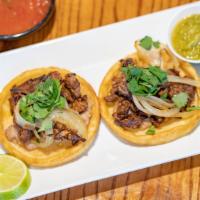 2 Al Carbon Sopes · Grilled skirt steak topped with caramelized onion cilantro and guajillo sauce.