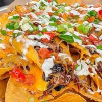 Southern Nachos · Tortilla chips layered with nacho cheese, a drizzle of our Western BBQ sauce, cheddar jack c...