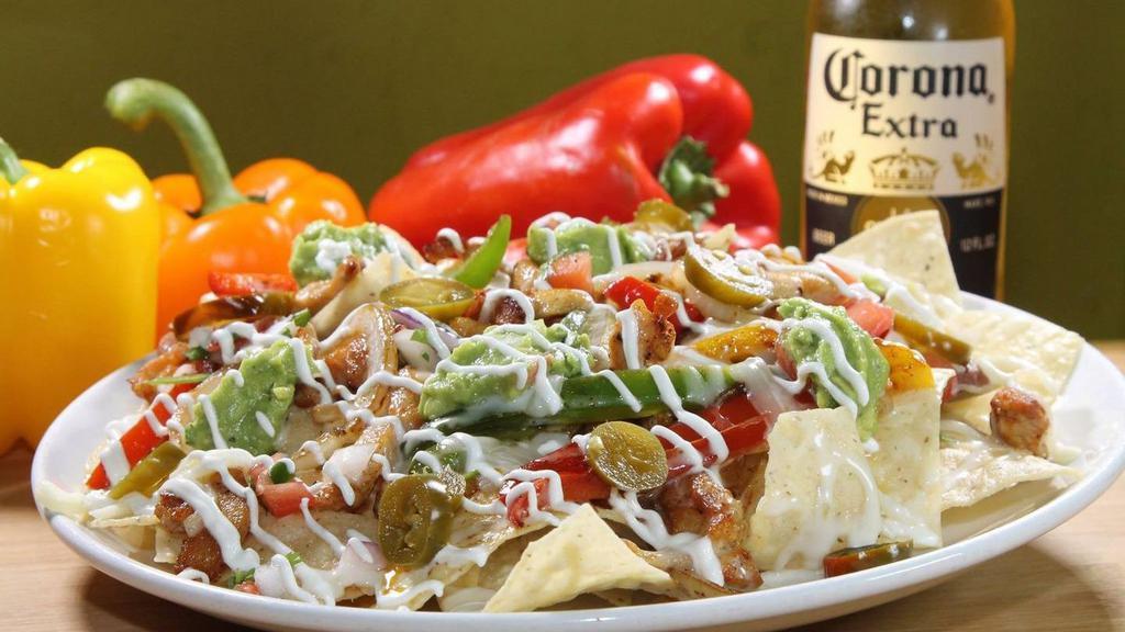 Nacho Supreme · Grilled and seasoned your choice chicken, steak, or ground beef cooked with bell peppers and onions. Topped with beans, pico De gallo, sour cream, guacamole, pickled jalapenos, mozzarella cheese, and cheese dip.