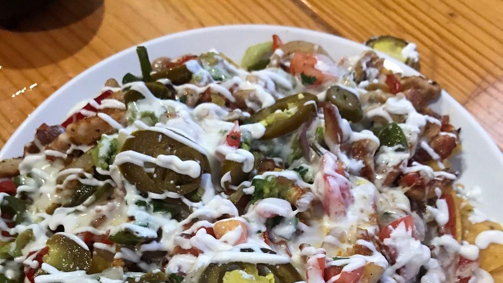 Nachos Fajita · Grilled and seasoned, your choice of chicken, steak, or ground beef cooked with bell peppers and onions. Topped with beans, mozzarella cheese, and cheese dip.