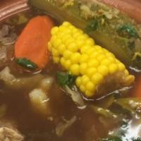 Pozole Soup · Cooked with white hominy guajillo pepper, oregano, lettuce, cilantro, onions, radish, and cr...