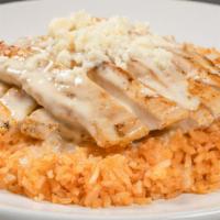 Cardinal Special · A bed of rice topped with a grilled chicken breast smothered in queso.