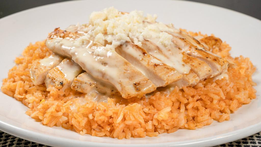 Cardinal Special · A bed of rice topped with a grilled chicken breast smothered in queso.