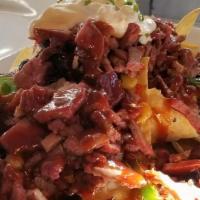 Bbq Brisket Nachos · BBQ brisket on top of tortilla chips covered with queso and cheddar cheese, black bean salsa...