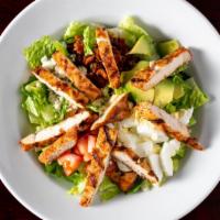 Cobb Salad · Romaine lettuce, tomatoes, bacon, egg, avocado, Blue cheese crumbles, onions and Cheddar che...