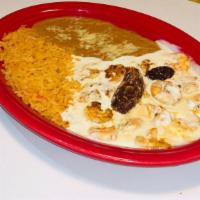 Camarones Al Chipotle · Plump tender grilled shrimp in a spicy chipotle cream sauce, served with rice refried beans,...
