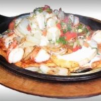 El Norteño · Sizzling skillet heaping with grilled shrimp and chicken or steak and shrimp, onions and pin...