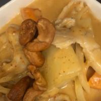 Massaman Curry · Thai massaman curry with potatoes, onion, cabbage and cashews on top.