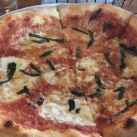 Margherita Pizza · Marinara, fresh mozzarella, tomatoes, olive oil, topped with fresh basil.