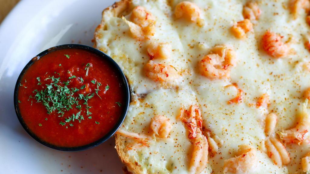 Crawfish Bread · French bread topped with Alfredo sauce, crawfish tails and mozzarella.