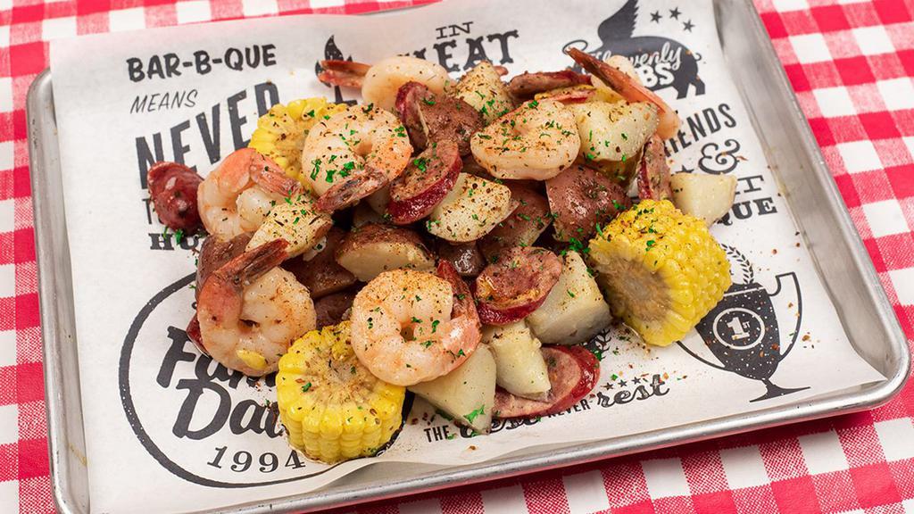 Famous Cajun Shrimp Boil · Tender, succulent boiled Shrimp and fresh Red Potatoes tossed with grilled Sausage and Corn, in house-made Cajun Butter and our very own Cajun Seasoning blend.