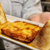 Opa! · Pan-seared feta, Tennessee honey drizzle, and baguette.