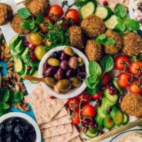 Mezze Platter · Assorted selection of specialties hummus, baba ganoush, grape leaves, tabbouleh, falafel, ki...
