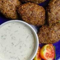 Fried Kibbeh Appetizer · two loaves of cracked wheat/ground beef crust stuffed with spiced ground lamb, onion, and pi...