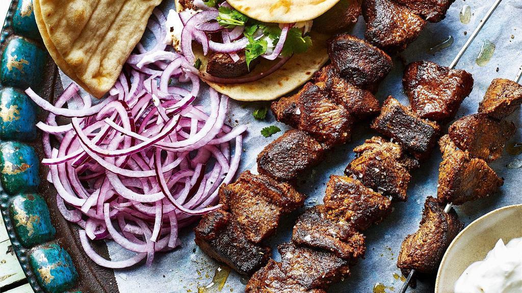 Lamb Shish Kebab · two skewer of Charbroiled tender lamb cubes marinated with special spices. Served with two sides of your choice of hummus+pita bread or salad or rice