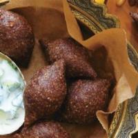 Fried Kibbeh Platter · Two kibbeh loaves with a cracked wheat and ground beef crust stuffed with spiced ground lamb...