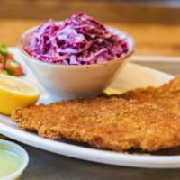 Chicken Schnitzel · Two panko crusted herb and citrus marinated chicken breasts served with cucumber tomato sala...